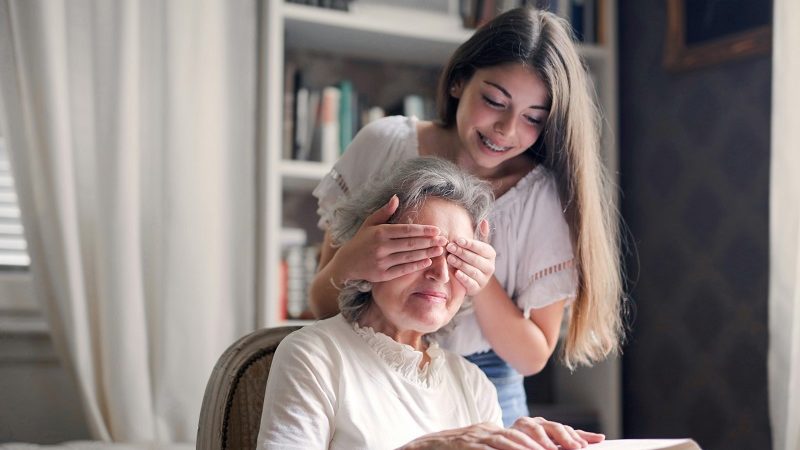 Young lady talking money from the elderly lady without the old ladies knowladge