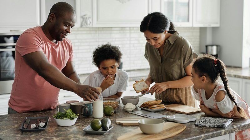 A family standing around the kitchen island