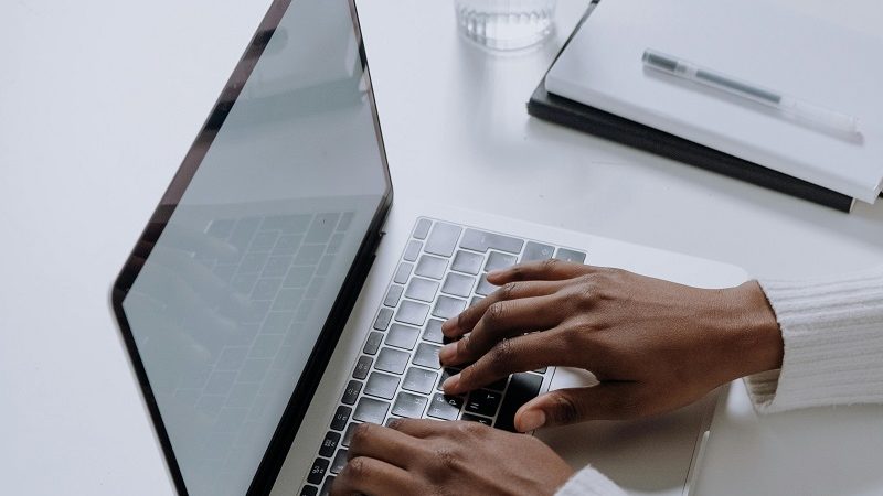 Person typing on their computer